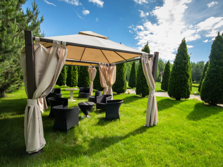 White,Canvas,Gazebo,With,Plastic,Garden,Furniture,In,A,Summer